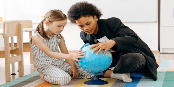 Mother and daughter with a globe